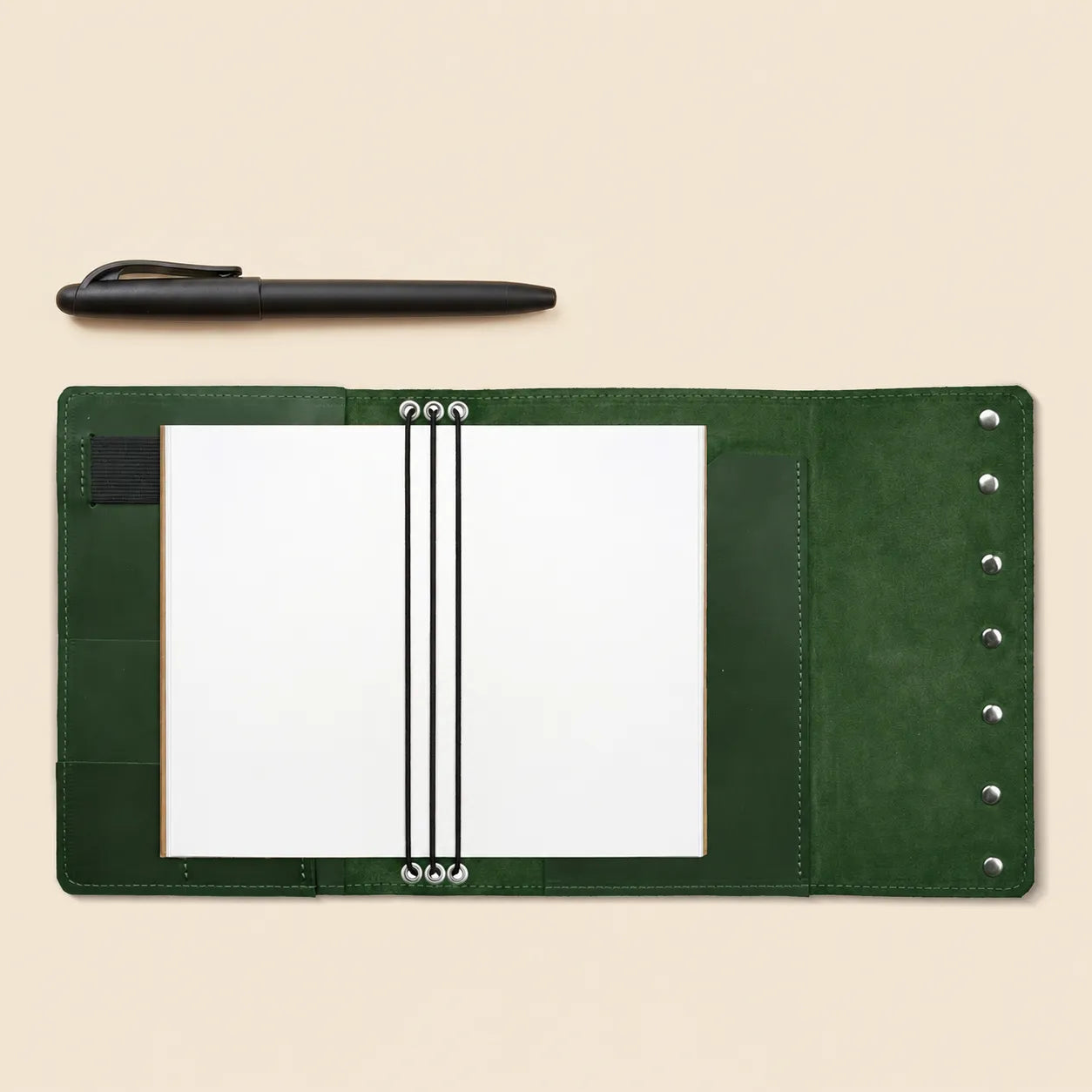 Premium leather planner cover with storage pockets and attached pen holder.