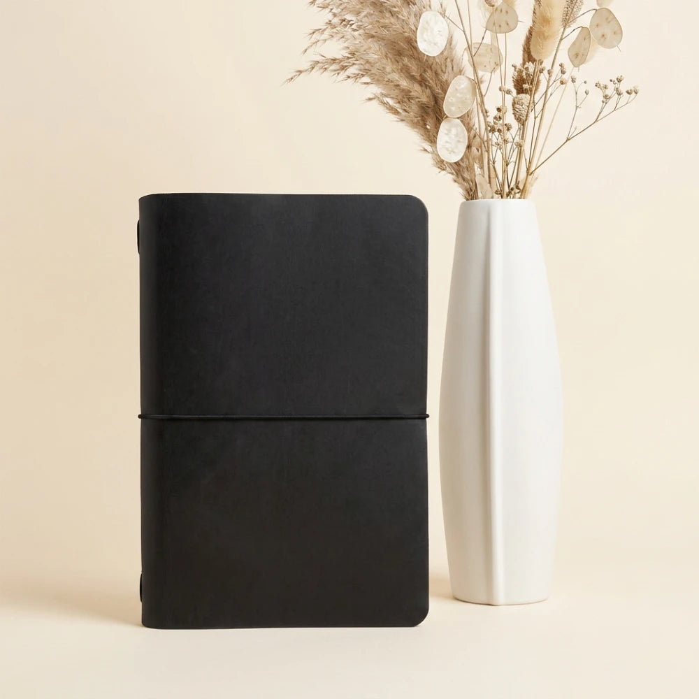 Sleek leather notebook wrap with one interior elastic for secure journal placement.