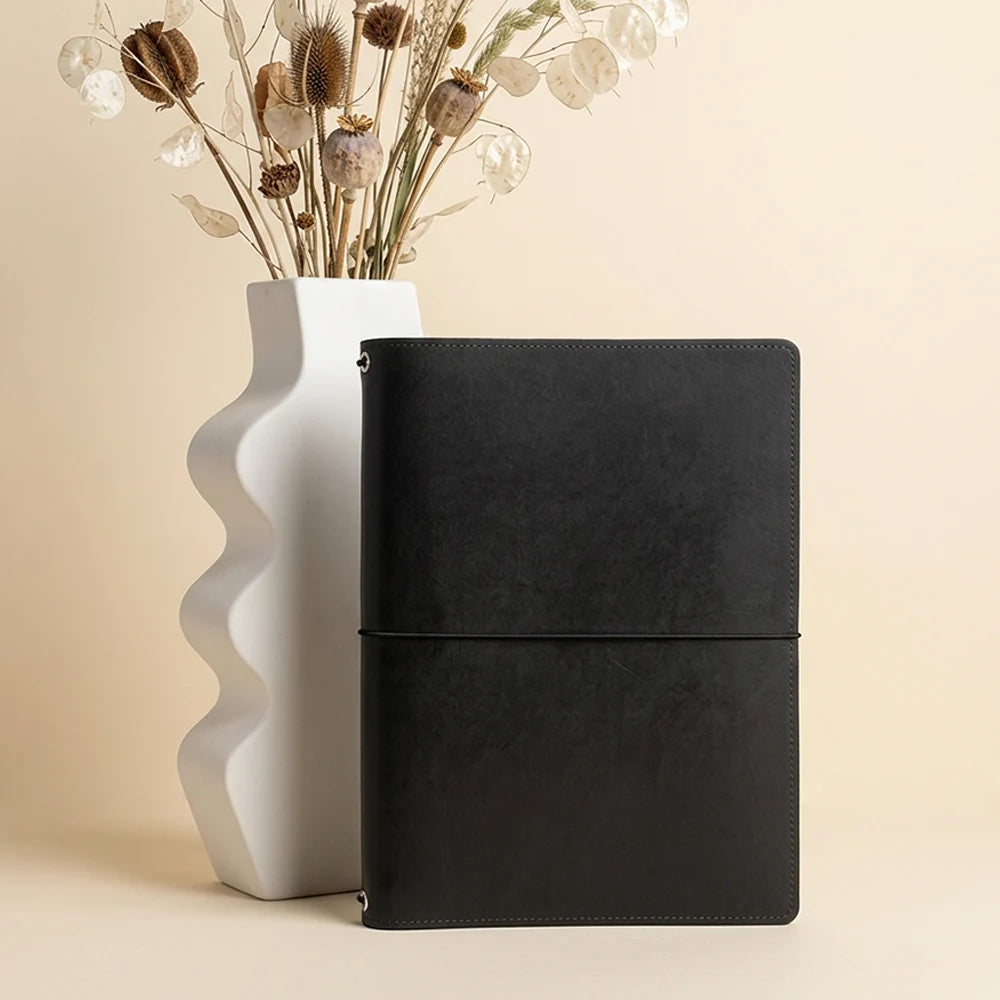 Handmade journal holder designed to keep sketchbooks and notebook inserts neatly together.
