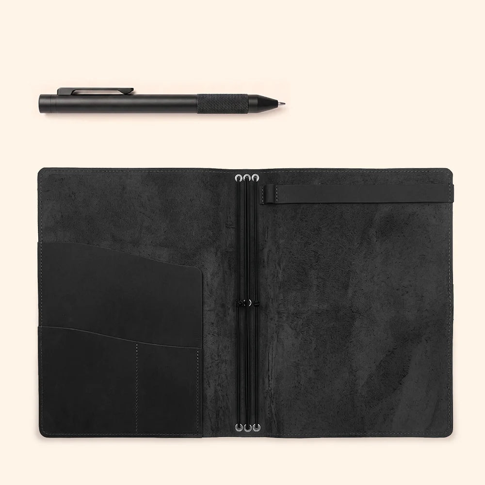 Open leather notebook holder with organized storage for inserts and stationery items