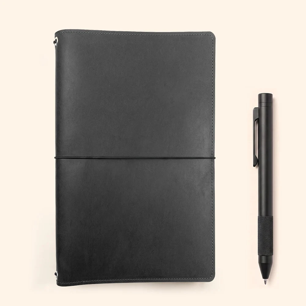 Leather sketchbook holder with internal elastic cords for carrying several notebook refills.