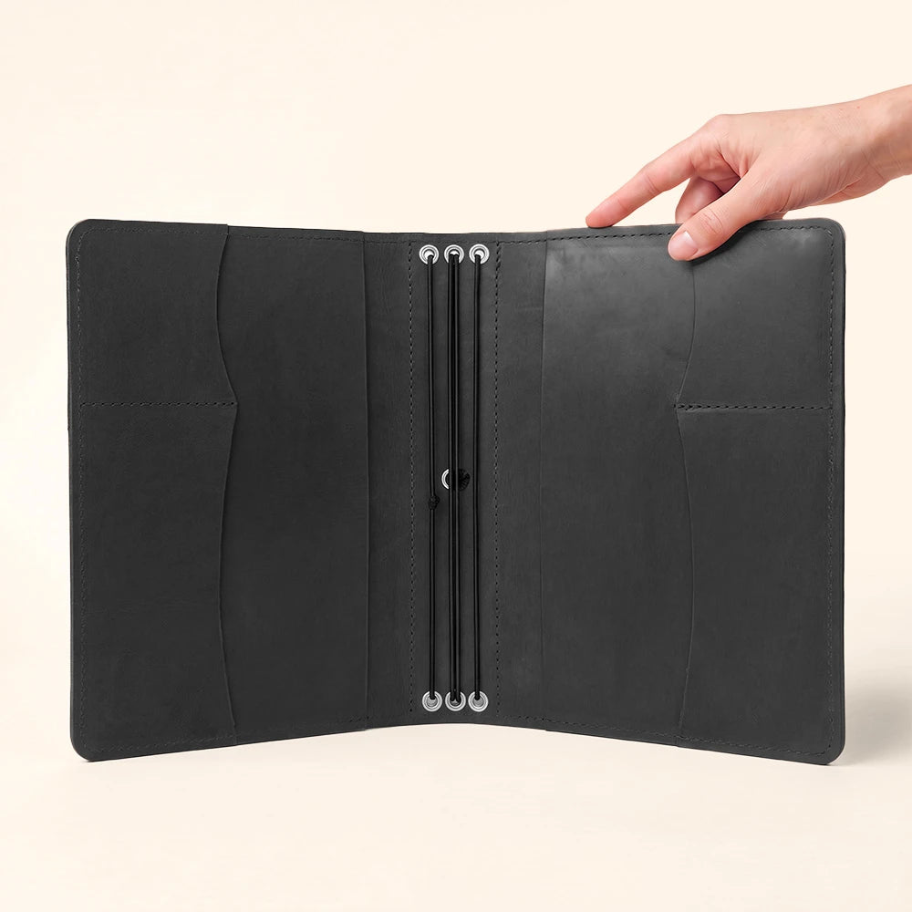 Handmade leather notebook case featuring organized pockets and secure stitched pen carrying loop.