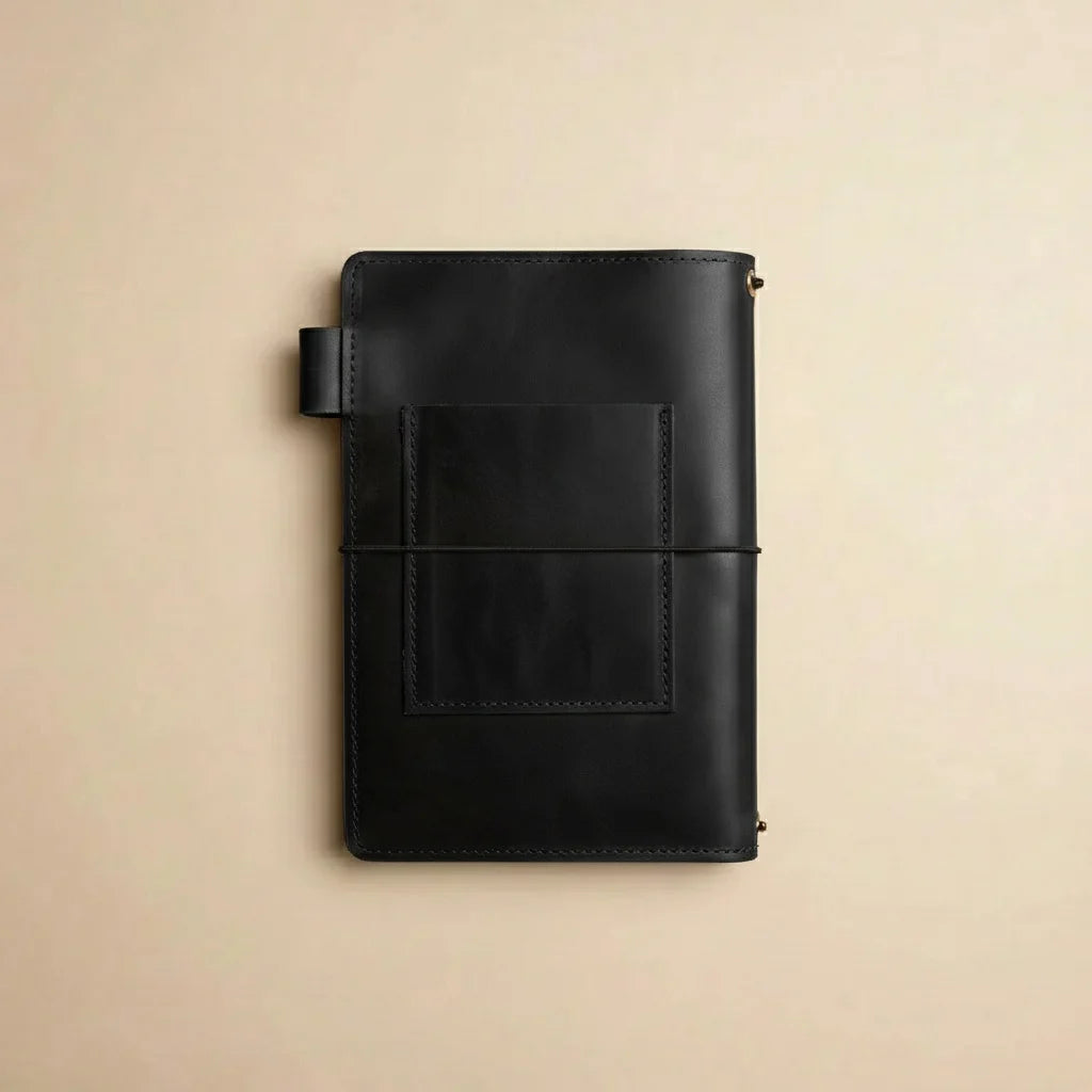 Black leather notebook on a beige background