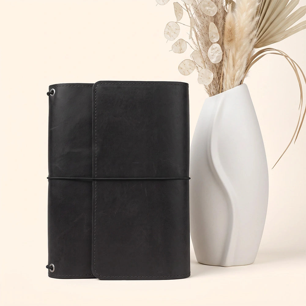Genuine leather notebook organizer designed with spacious pockets and dedicated pen keeper.