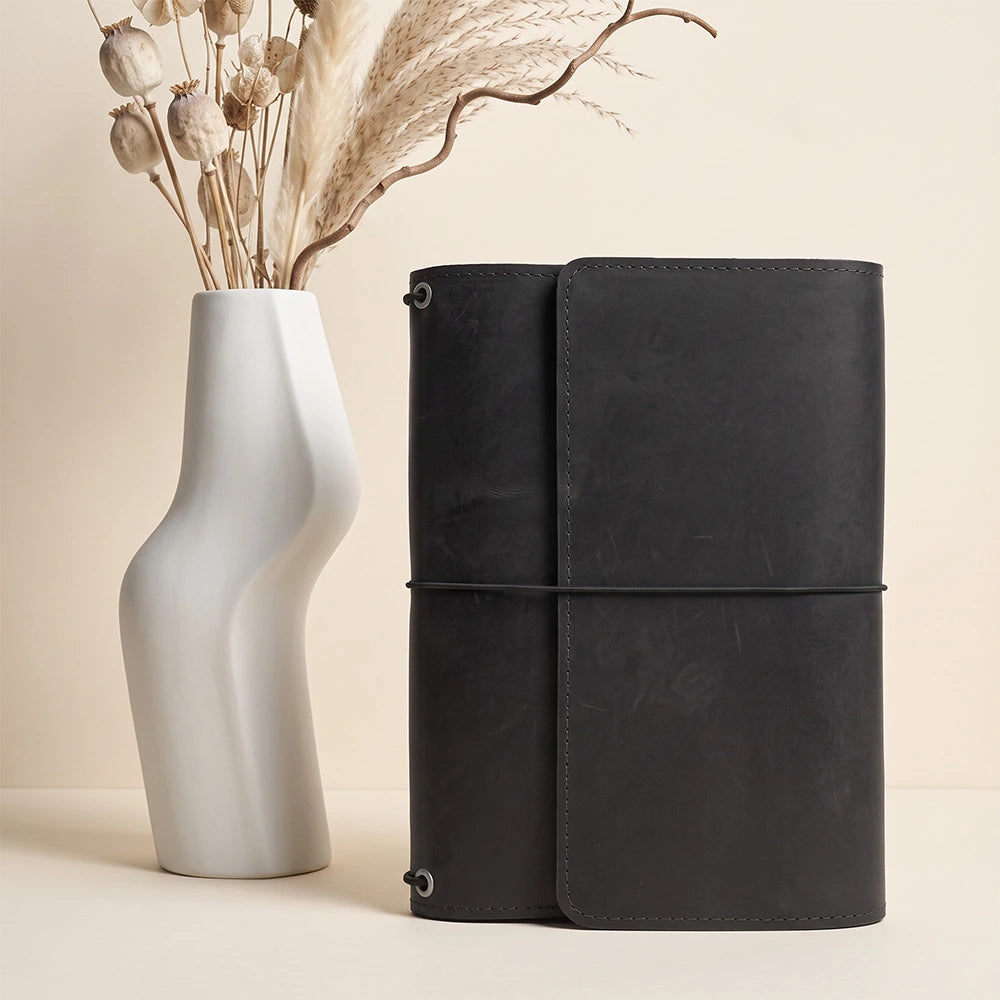 Leather notebook organizer with spacious inside pockets and secure leather pen loop feature.