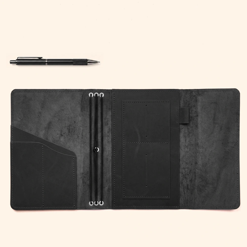 Leather notebook organizer with premium craftsmanship, inner compartments, and stitched pen sleeve.