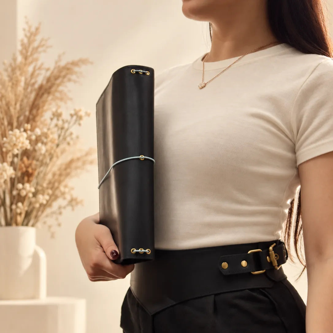 Woman holding a genuine leather notebook cover, emphasizing its handcrafted quality and natural appearance.