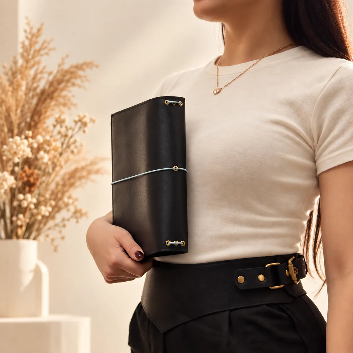 Woman showcasing a genuine leather cover designed for notebooks, journals, and everyday writing.