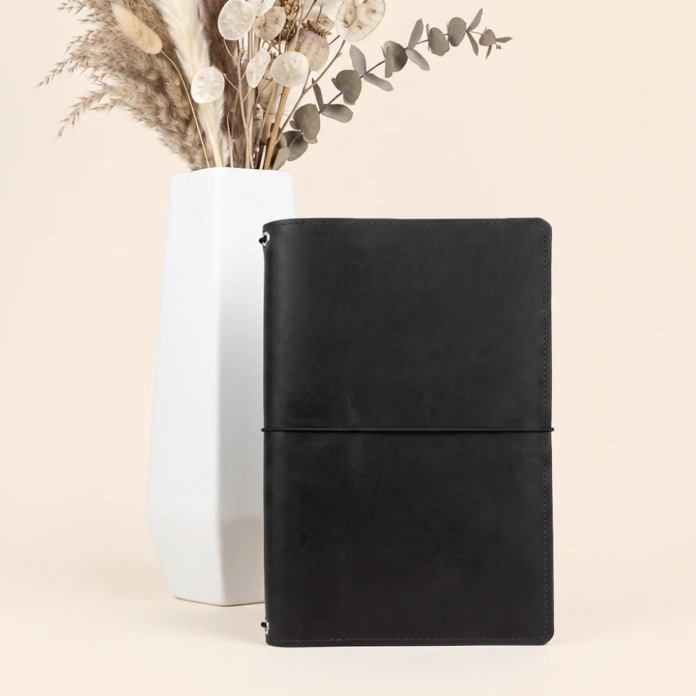 Natural leather notebook holder designed for three refillable inserts and flexible organization.