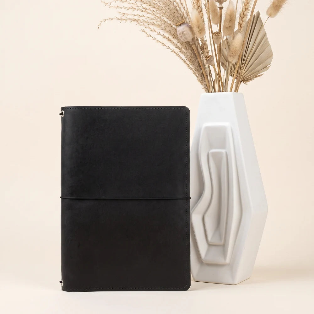 Durable natural leather notebook holder featuring three flexible elastic loops.