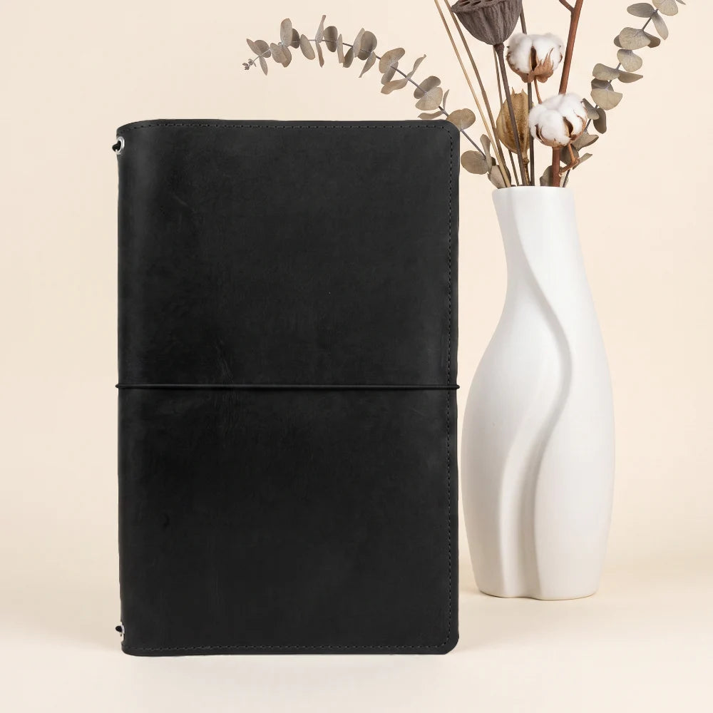 Compact journal organizer crafted from natural leather for three notebook refills.