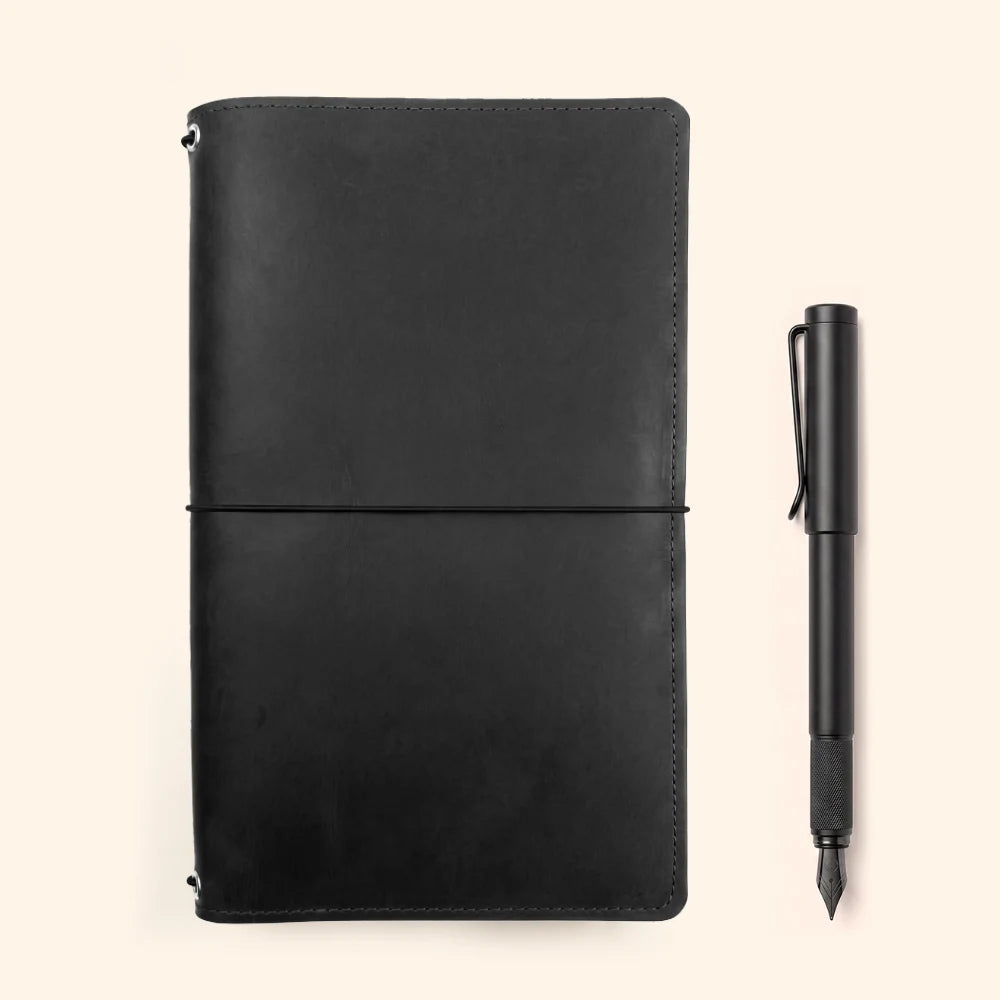 Handmade natural leather sleeve organizing three separate notebook booklets together.