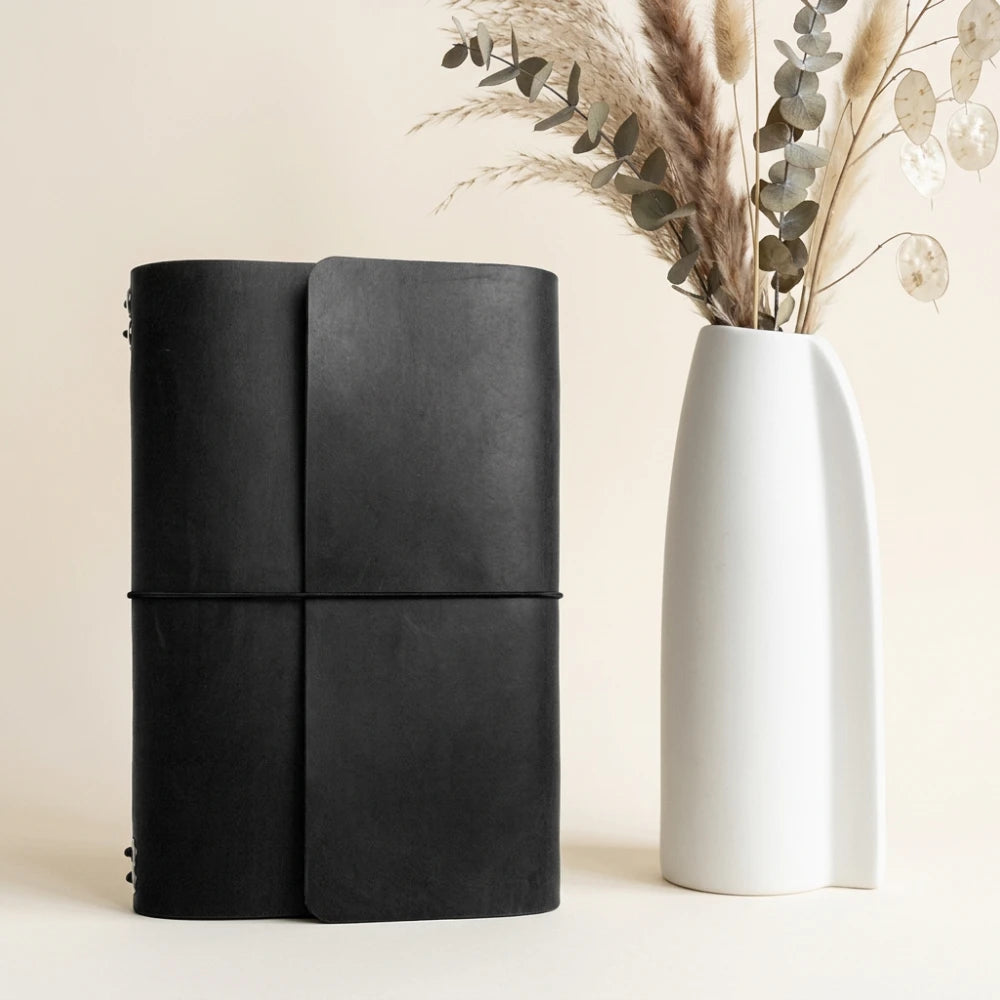 Premium refillable leather notebook cover supporting six separate inserts with elastic bands.
