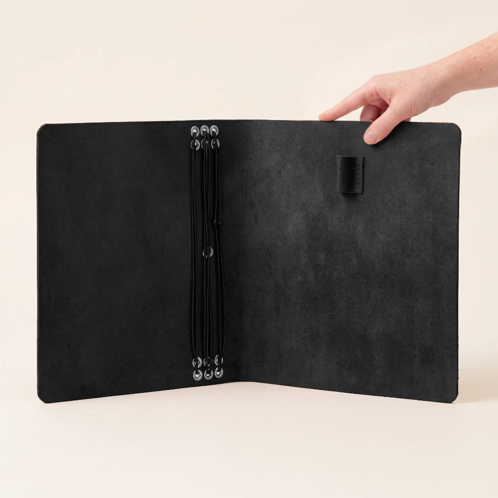 Handmade leather planner shell featuring six flexible attachment loops for notebook refills.