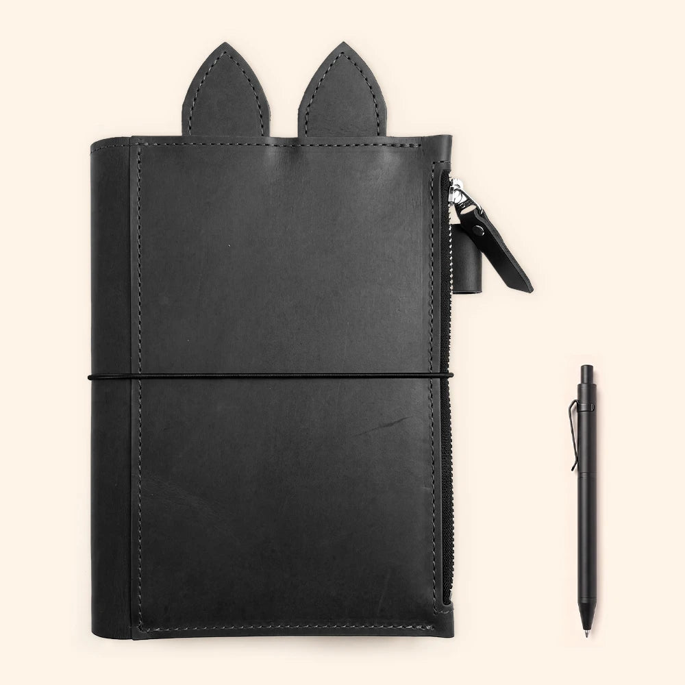 Refillable planner holder crafted with natural leather, elastic bands, and pen storage.