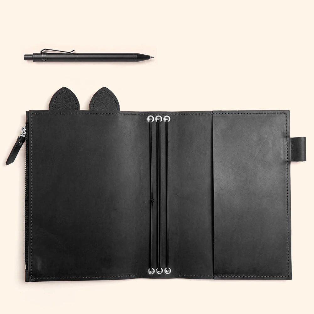 Handmade leather notebook case featuring spacious storage for accessories and writing supplies.