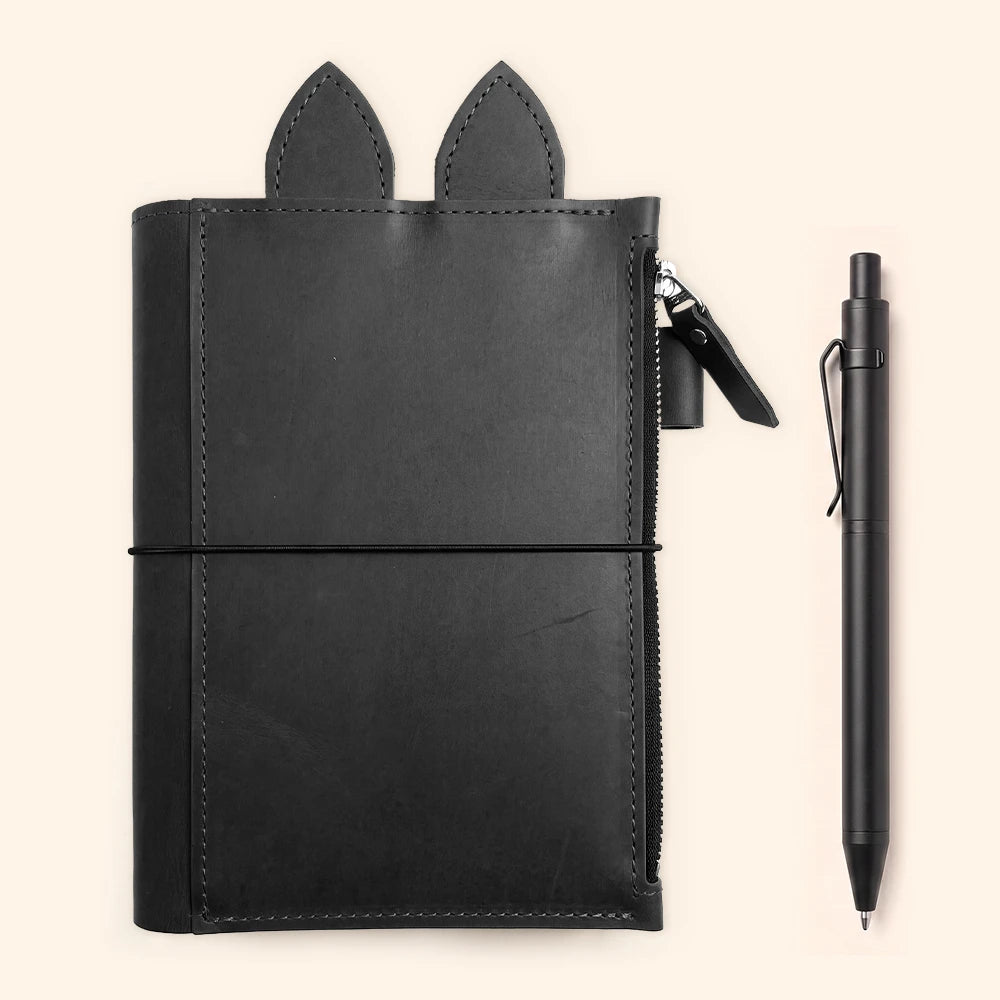 Handmade genuine leather journal cover displaying practical storage and unique ear-shaped accents.