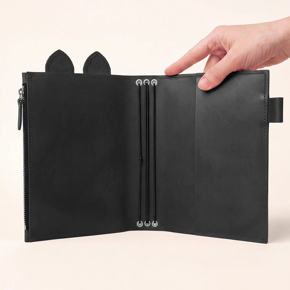 Black leather planner cover with spacious zipper pocket, pen holder, decorative leather ears, and bands.