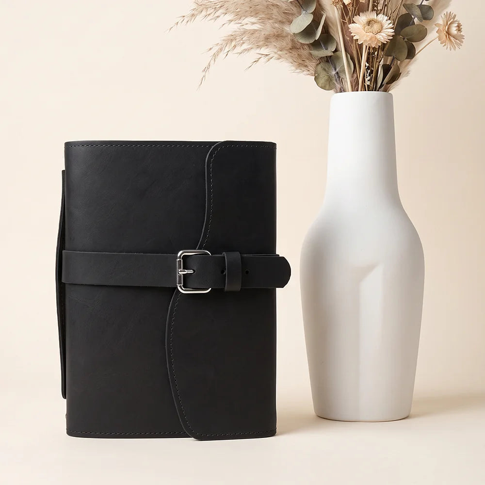 Genuine leather planner carrier with practical pockets, pen loop, attached marker, and sturdy external grip.