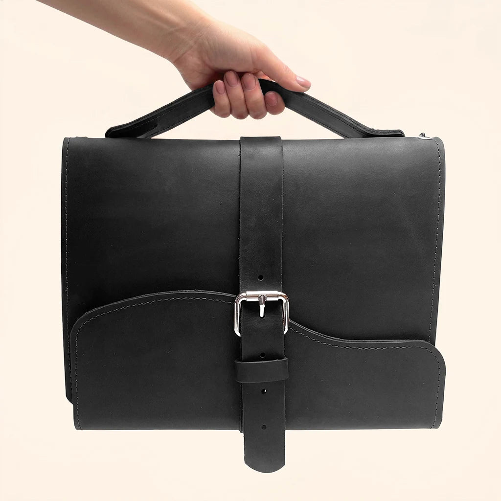 Premium leather travel organizer with three elastic straps and a convenient external handle.