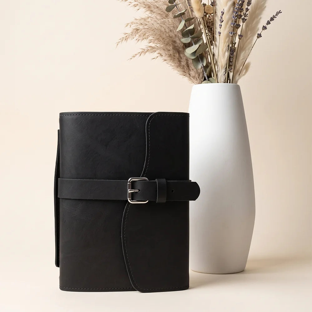 Natural leather notebook cover showcasing practical pockets, pen loop, integrated bookmark, and external carrying handle.