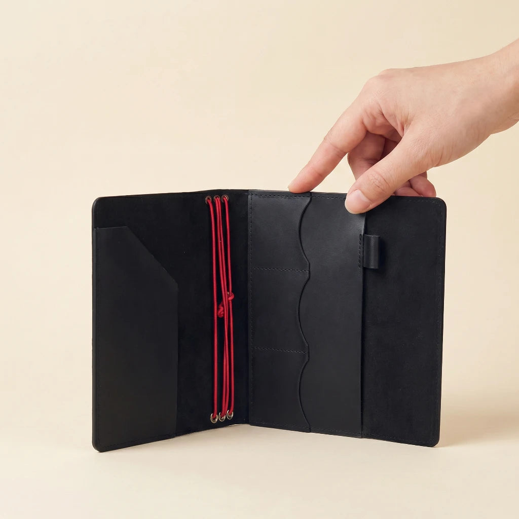 Genuine leather notebook wrap with elastic closure, pockets, and secure pen holder