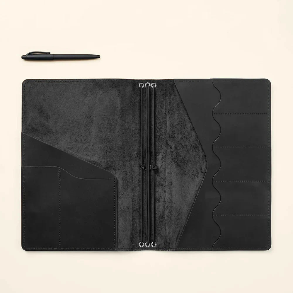 Handmade leather notebook sleeve with card organizers and refillable elastic notebook loops.