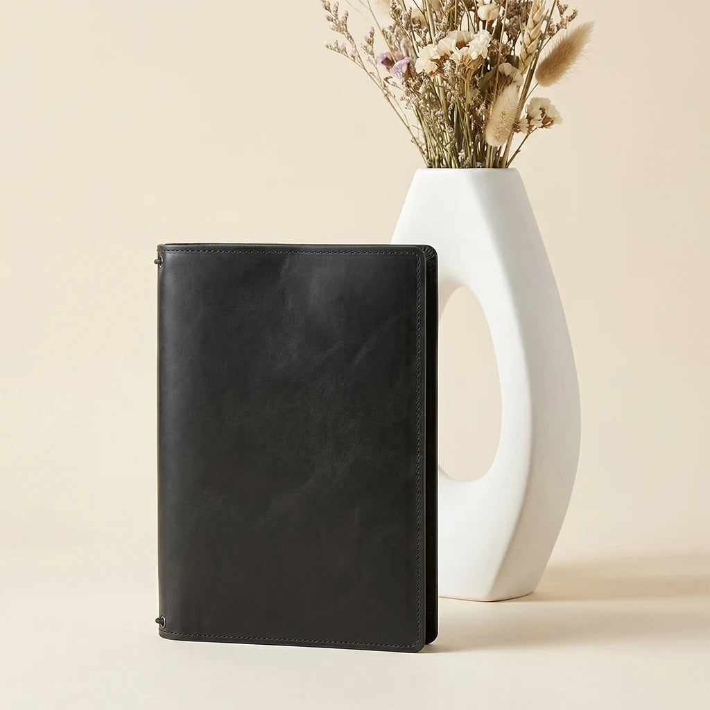 Handmade leather organizer featuring notebook retention and document storage compartments.