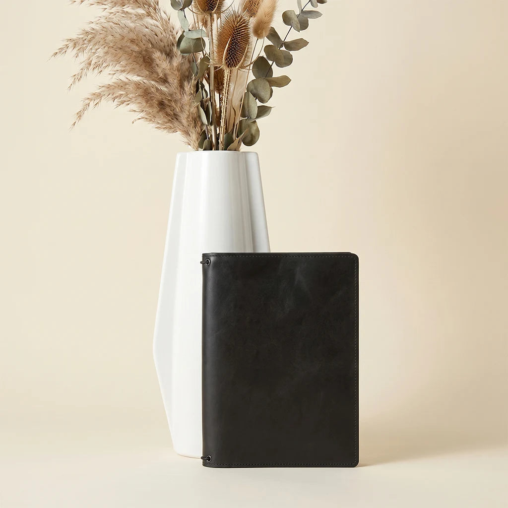 Leather notebook organizer displaying spacious interior layout and refillable design.