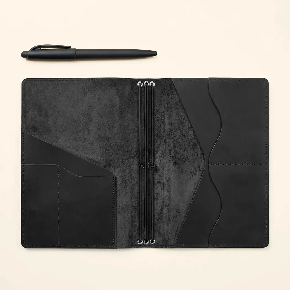 Premium leather journal cover with refillable design, interior pockets, and elastic notebook holders.