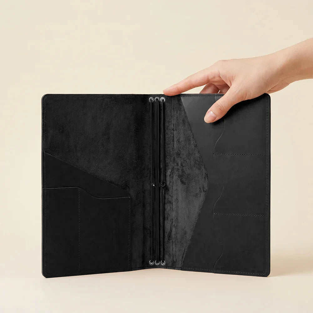 Leather notebook portfolio with refillable elastic bands and built-in storage pockets.