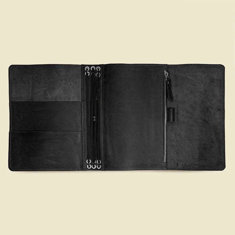 Natural leather journal cover with organized interior compartments and six elastic bands.