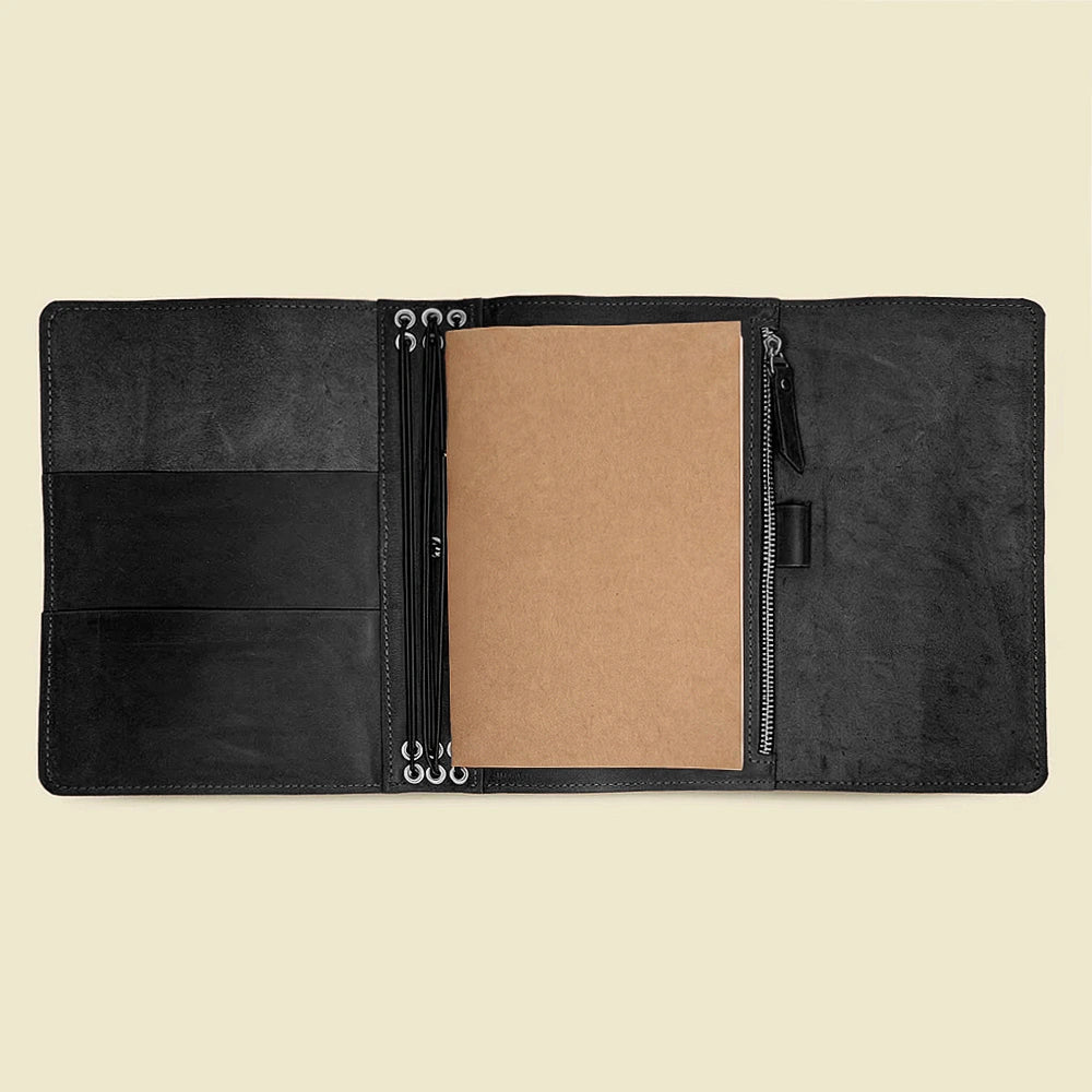 Leather journal cover showcasing interior storage pockets and six durable elastic bands.