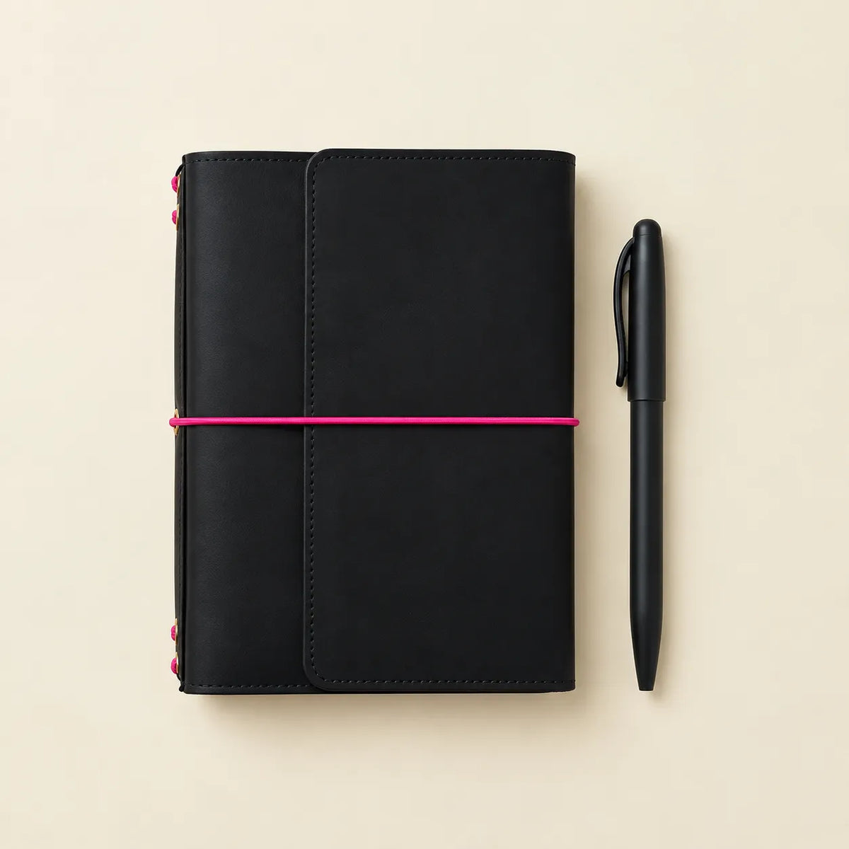Handmade leather notebook cover featuring a black finish and pink elastics