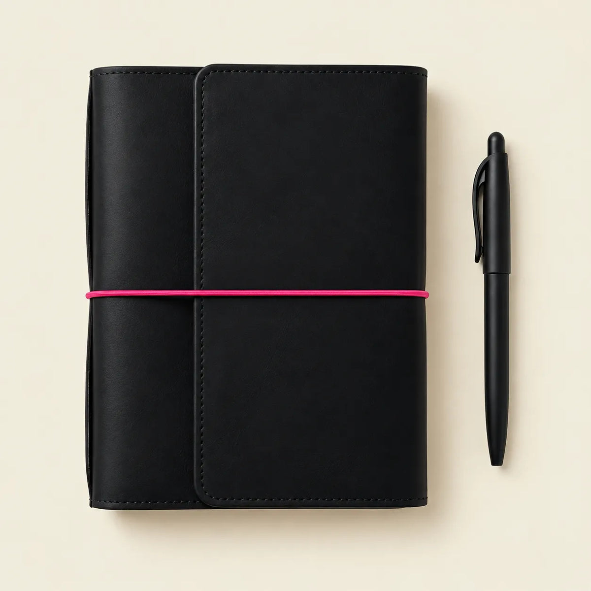 Genuine leather journal cover in black with contrasting pink elastic closures