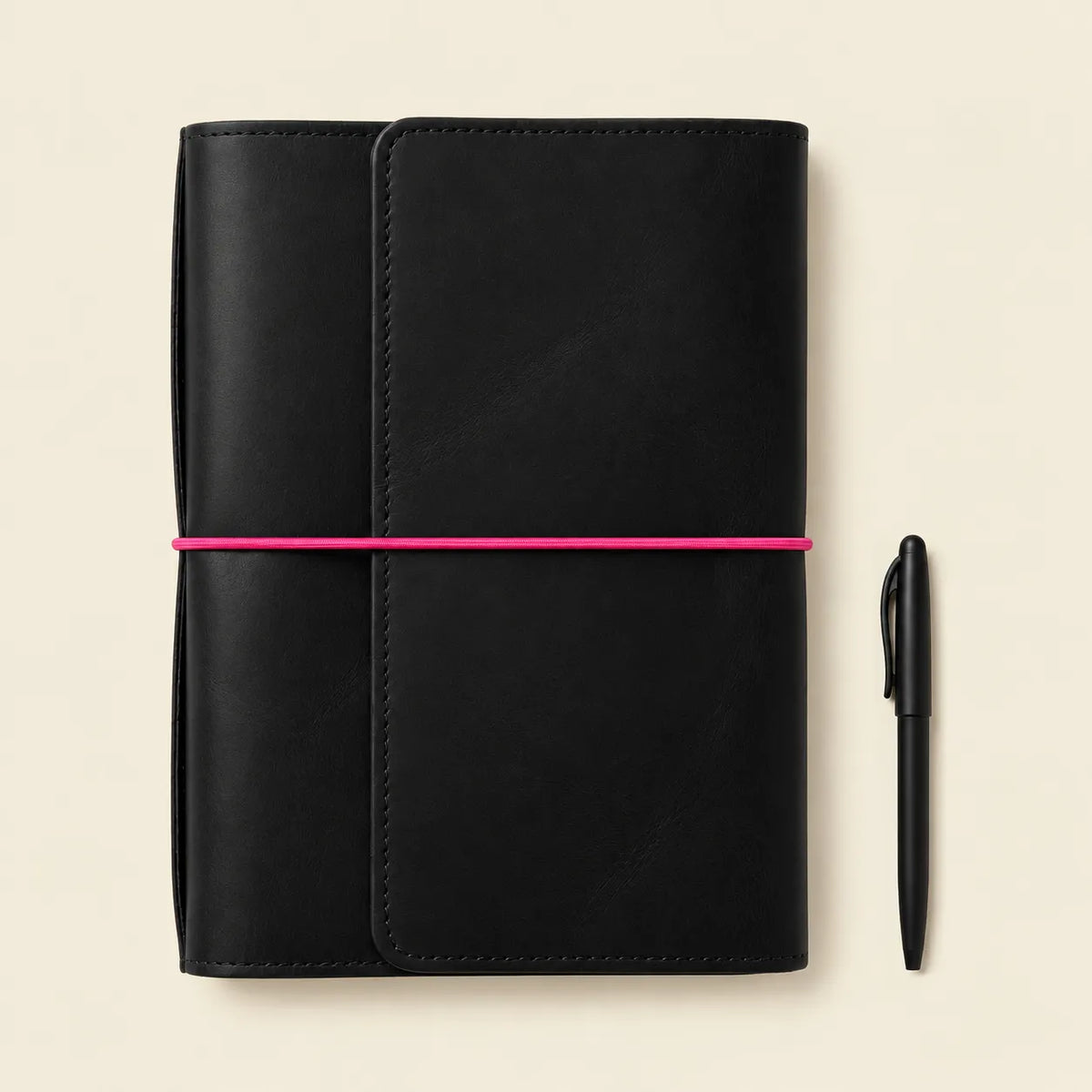 Handmade black leather notebook cover with decorative pink elastic bands