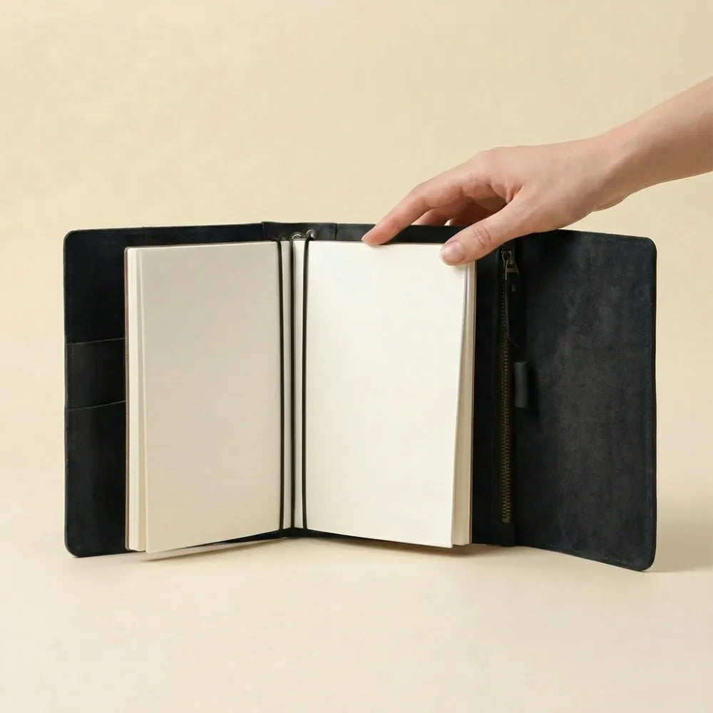 Leather travel journal cover offering storage, pen holder, and elastics.