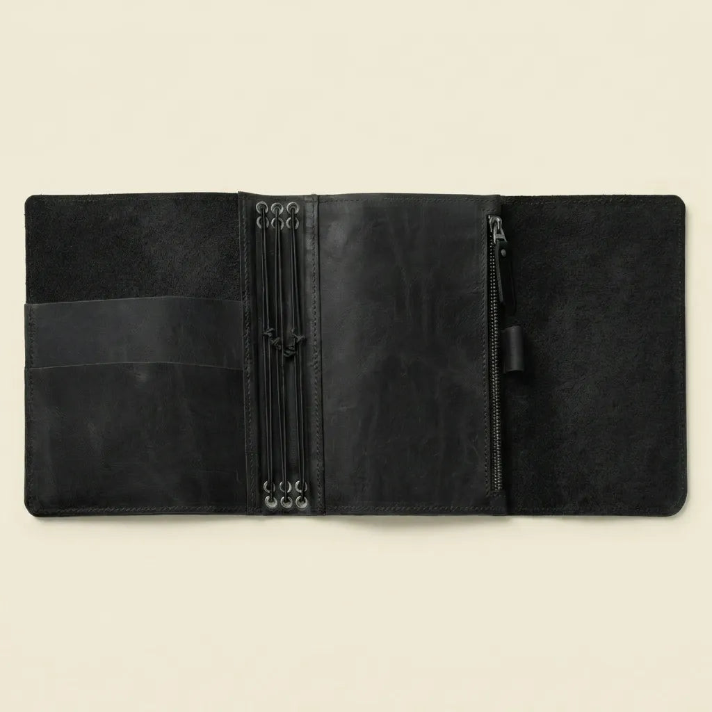 Durable leather notebook cover with elegant design and practical compartments.