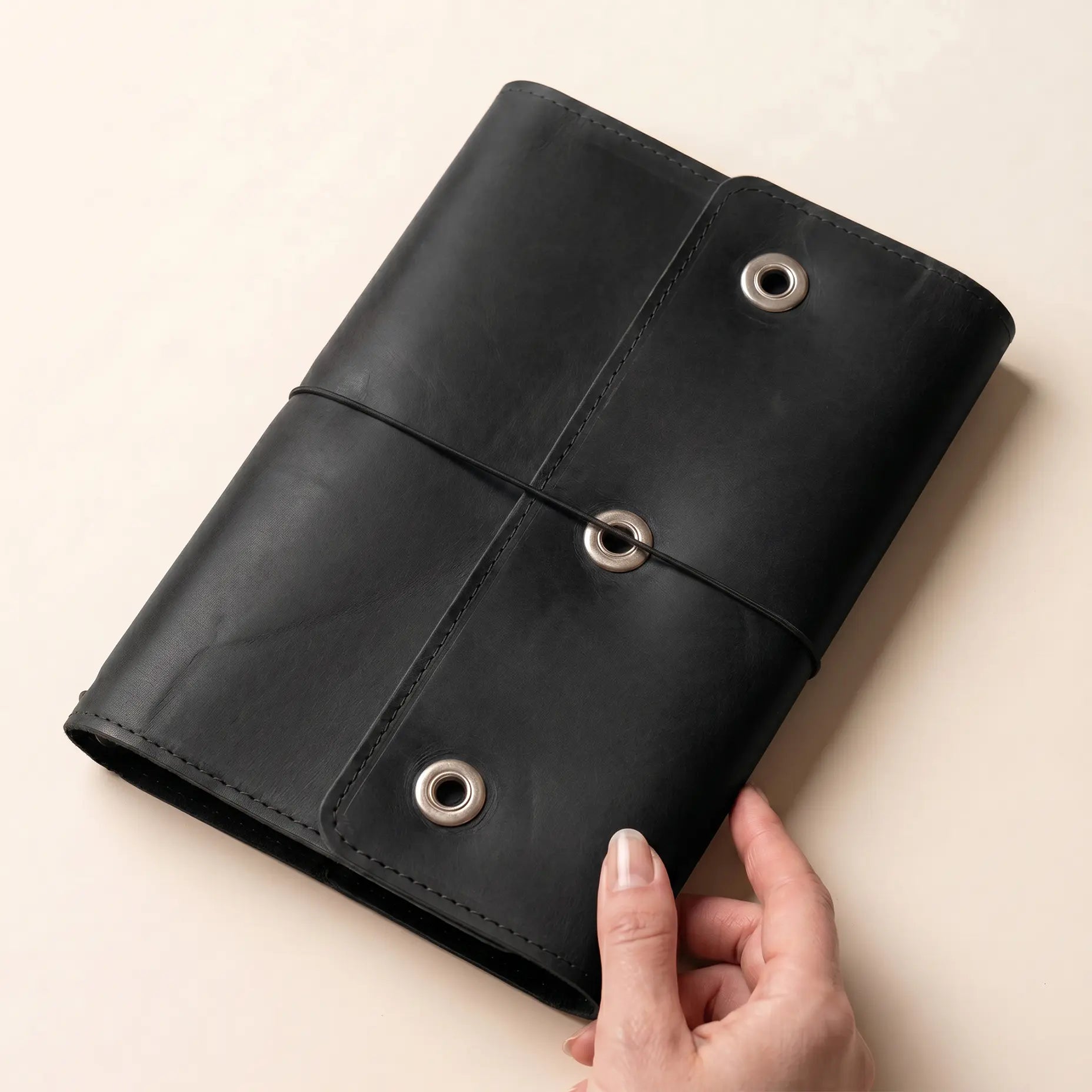 Leather planner cover with refillable inserts and convenient pen loop.