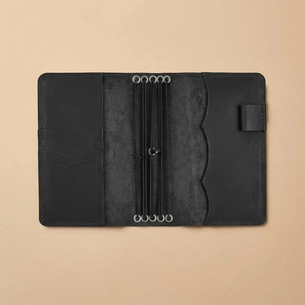 Leather travel notebook cover designed with five elastic insert straps.