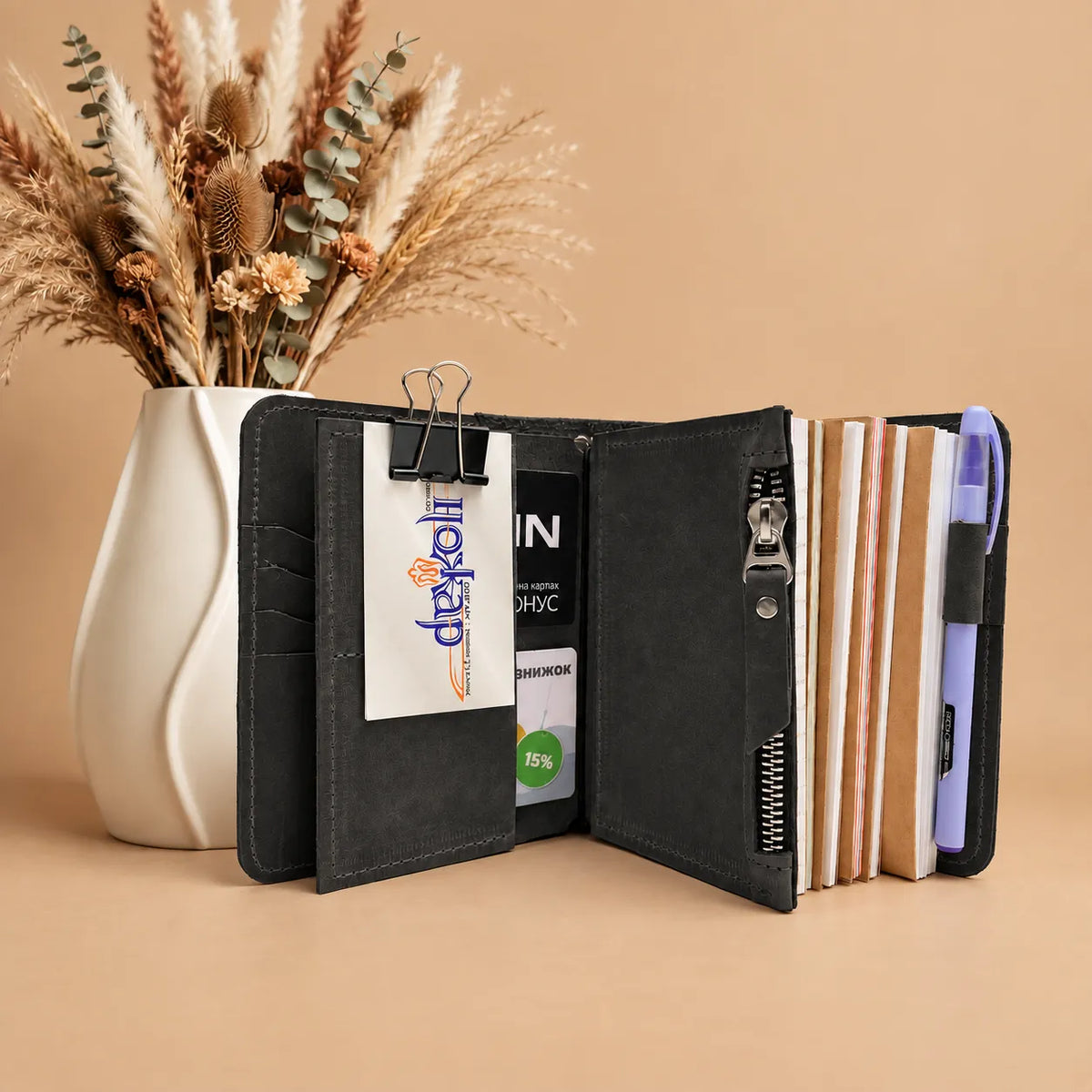 Natural leather notebook cover with five elastic bands for securing multiple inserts.