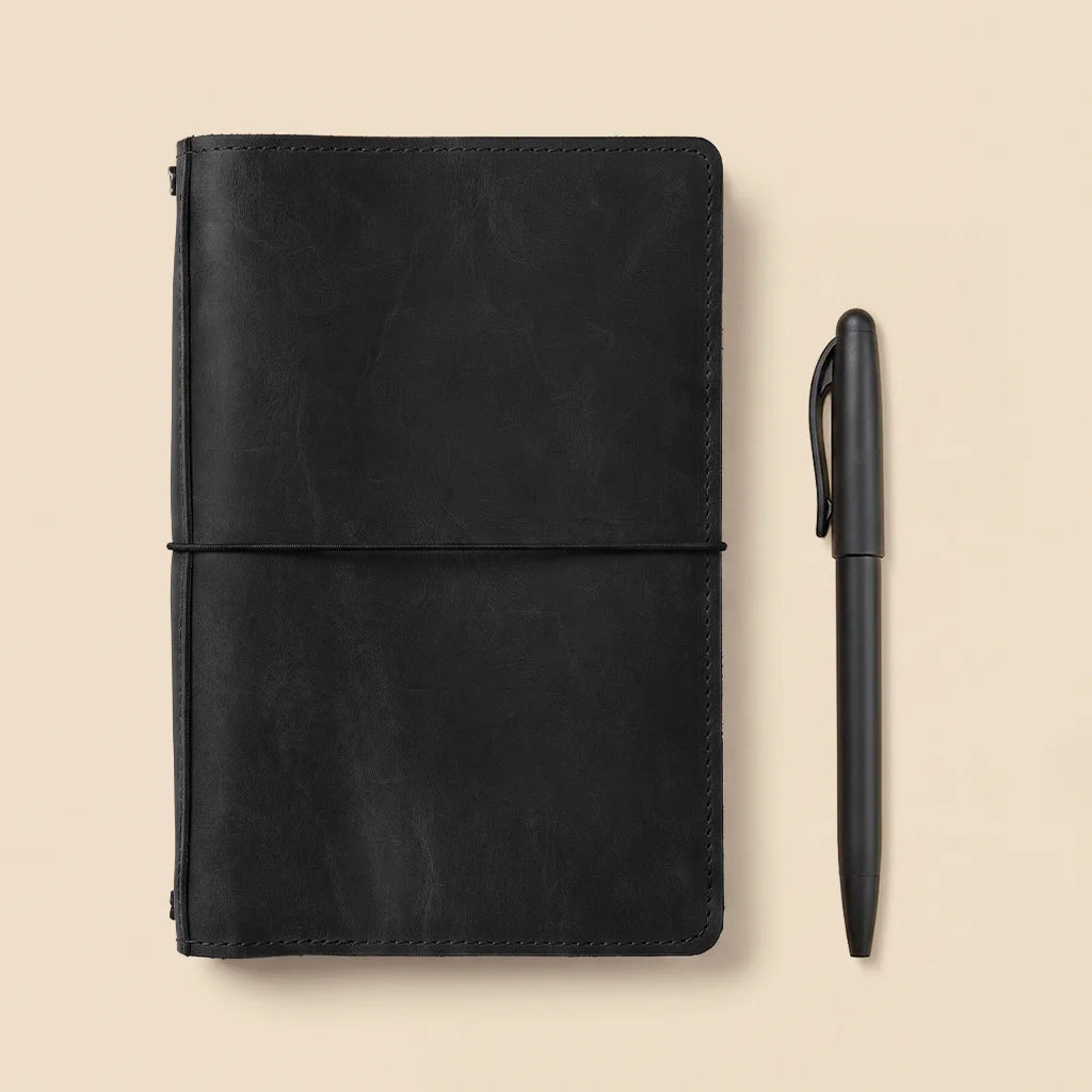 Leather planner cover combining premium craftsmanship with elastic notebook retaining cords.