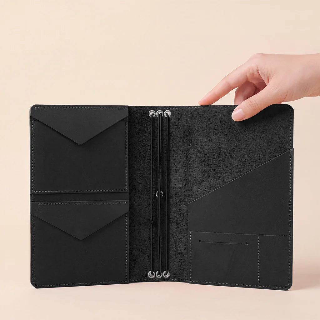 Premium refillable journal cover crafted from genuine leather with interior storage pockets.