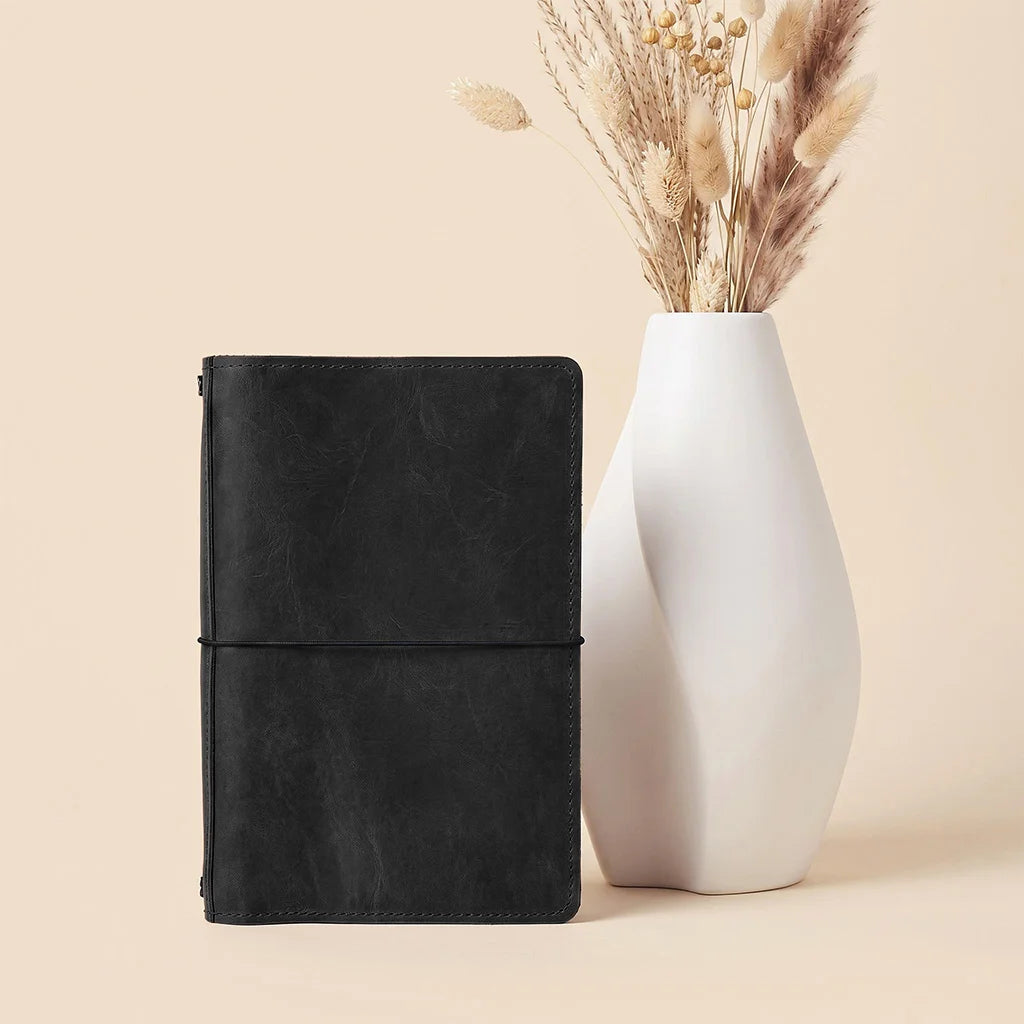 Premium leather journal cover featuring interior card storage and multiple elastic notebook holders.