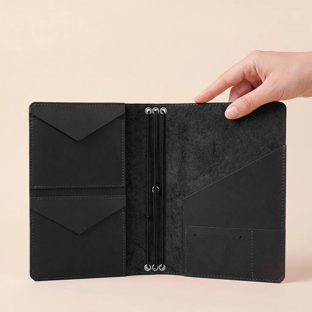 Handmade leather notebook cover with elegant pockets and refillable elastic insert organization system.