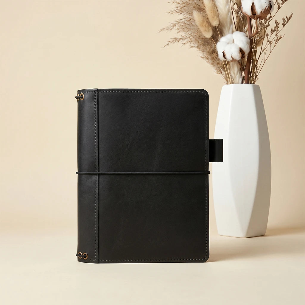 Leather notebook organizer featuring elastic insert cords and practical compartments