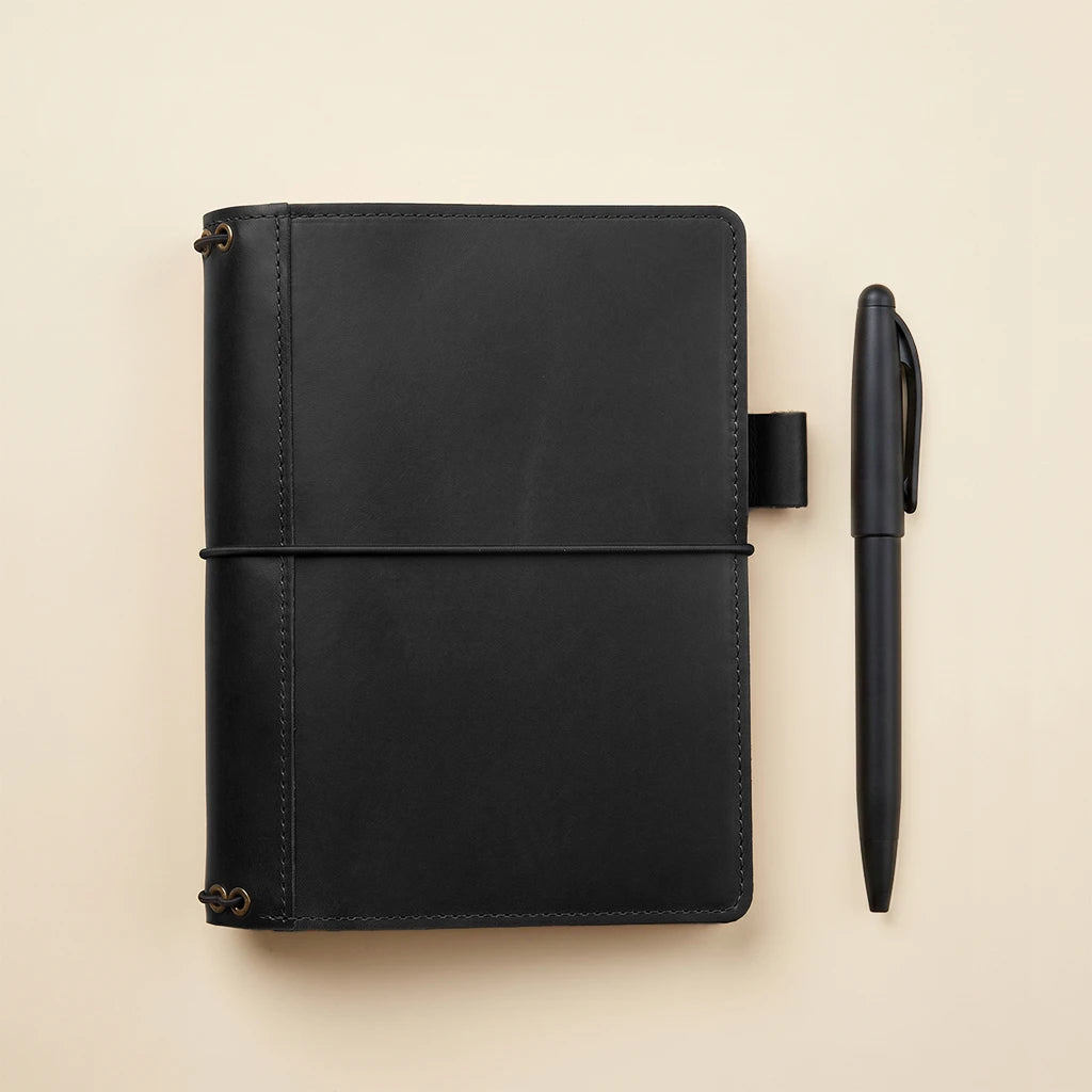 Handmade leather journal sleeve with refillable design and pen holder inside