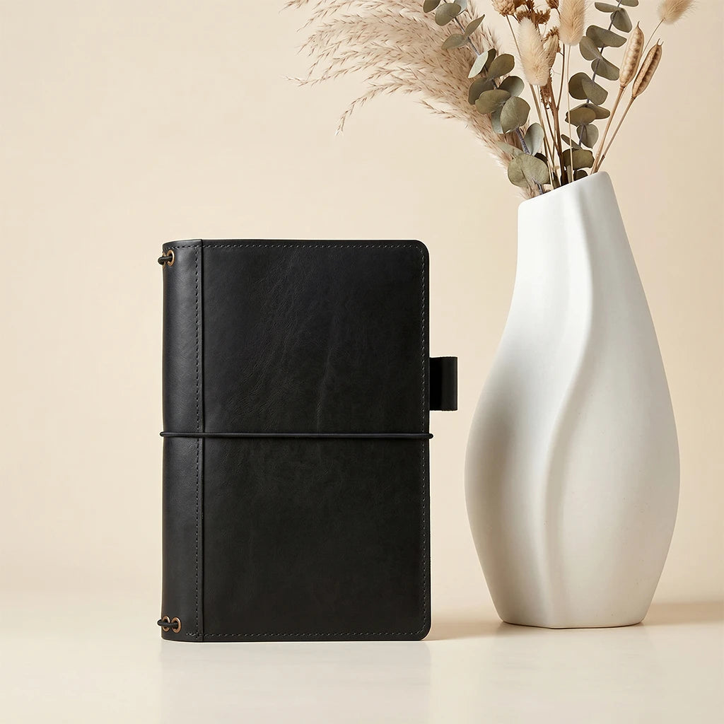 Leather notebook cover with refillable structure and practical interior compartments