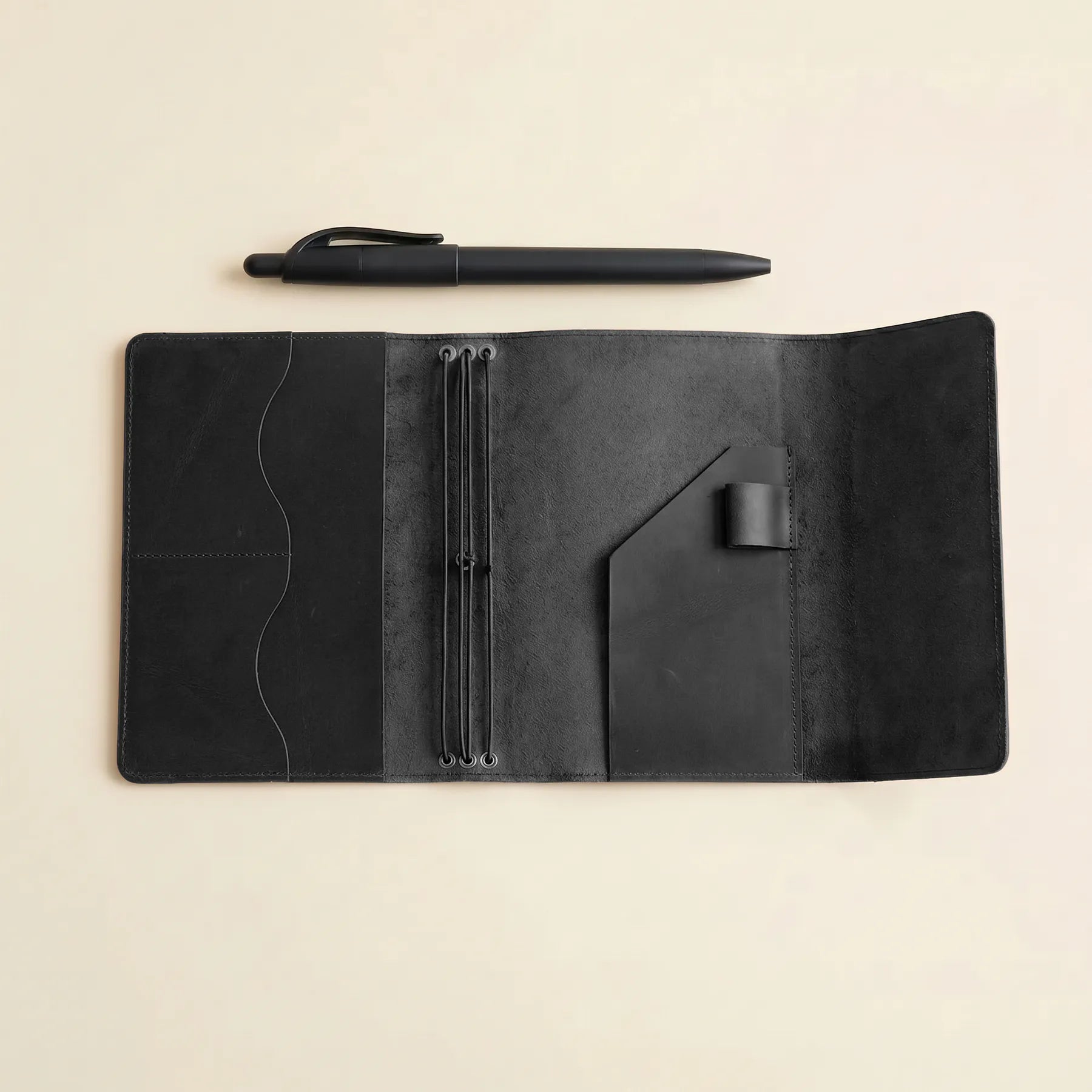 Handmade journal cover with inner pockets, pen holder, and elastic system.