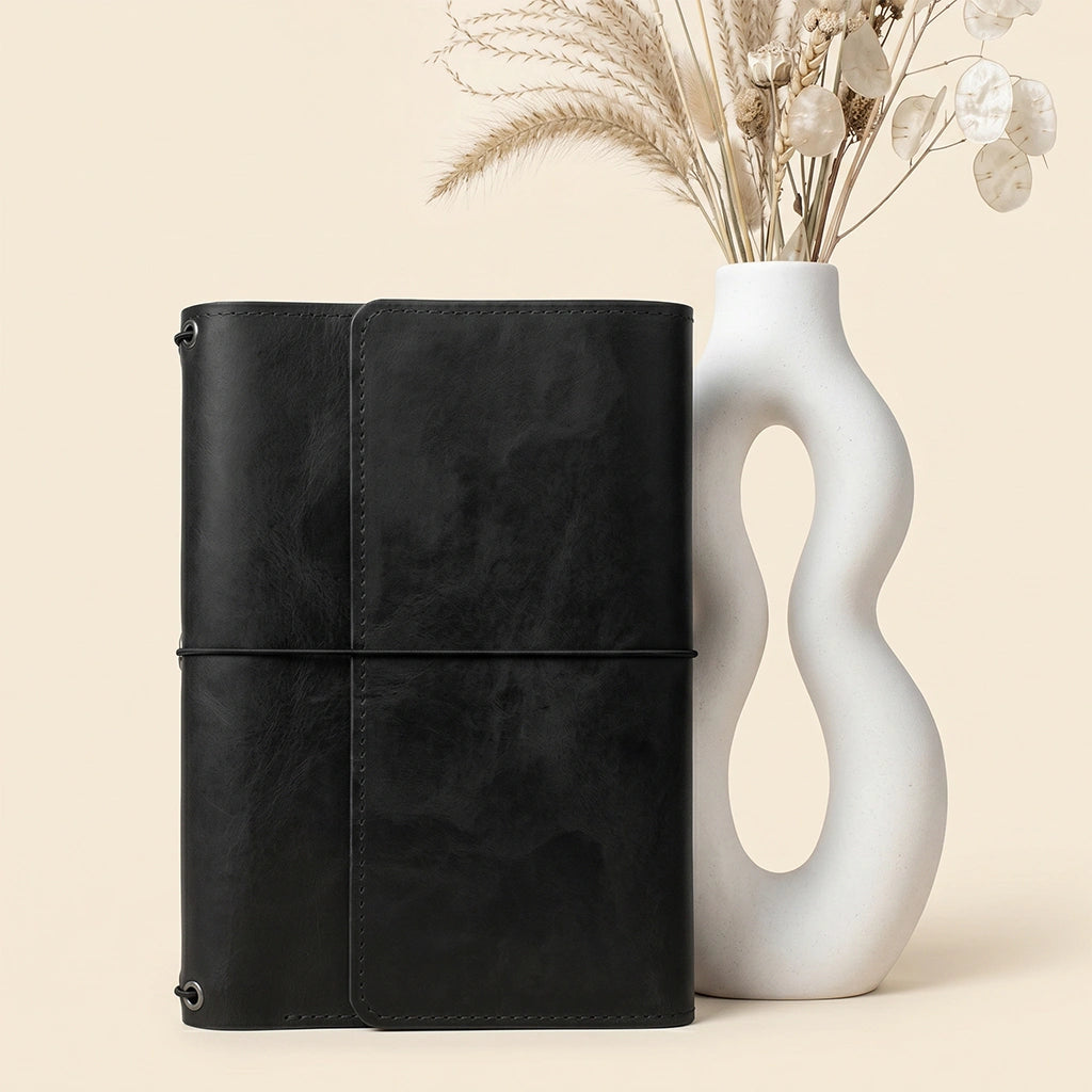 Premium leather notebook cover combining classic craftsmanship with practical organizer functionality.